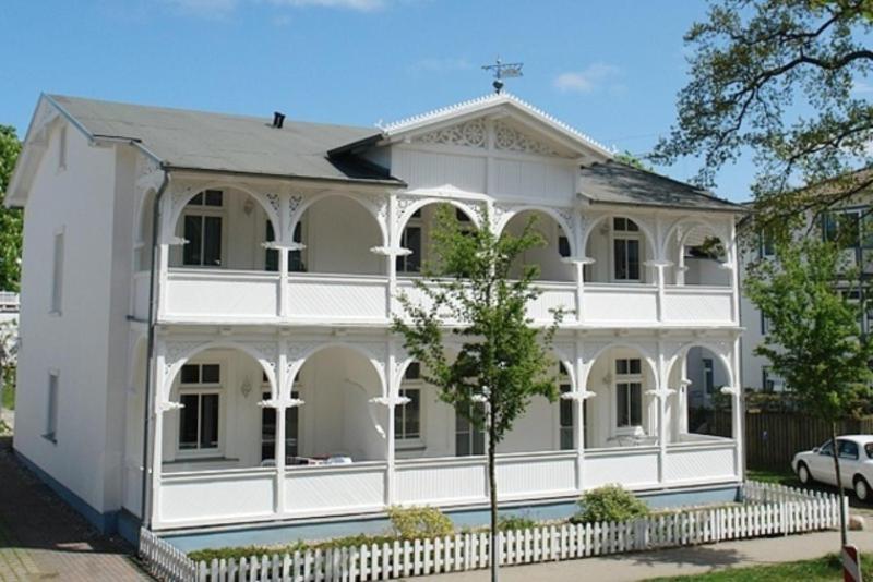 a white house with a white fence in front of it at Villa Hans by Rujana in Binz