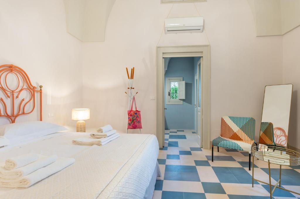 a bedroom with a bed and a checkerboard floor at Donna Zaira rooms&suites in Maglie