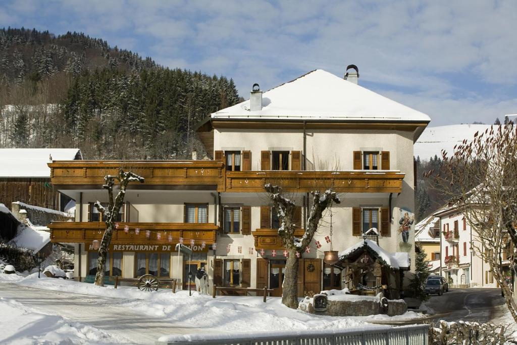 a large building with snow on the ground at Hotel de l'Union in Lullin