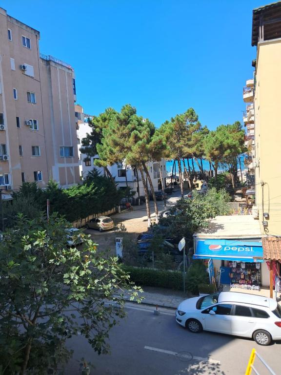 a car parked in a parking lot next to a building at Apartments Keesi 2 in Durrës