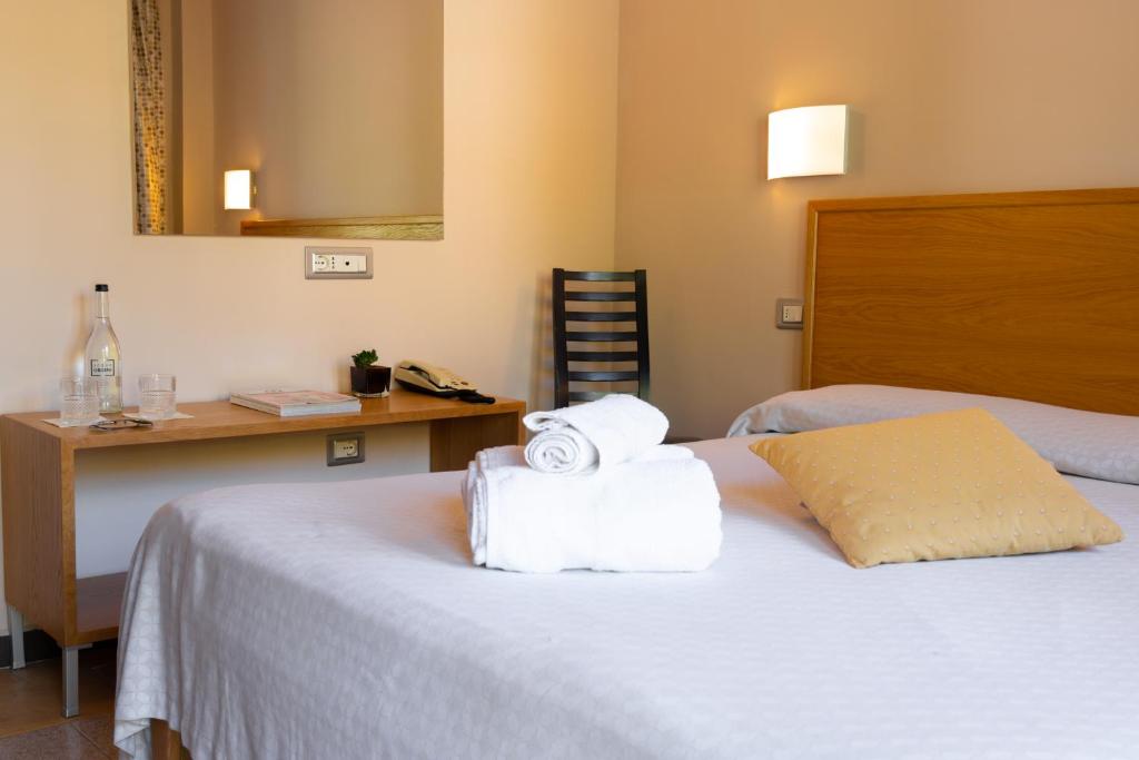Postel nebo postele na pokoji v ubytování Hotel Garden