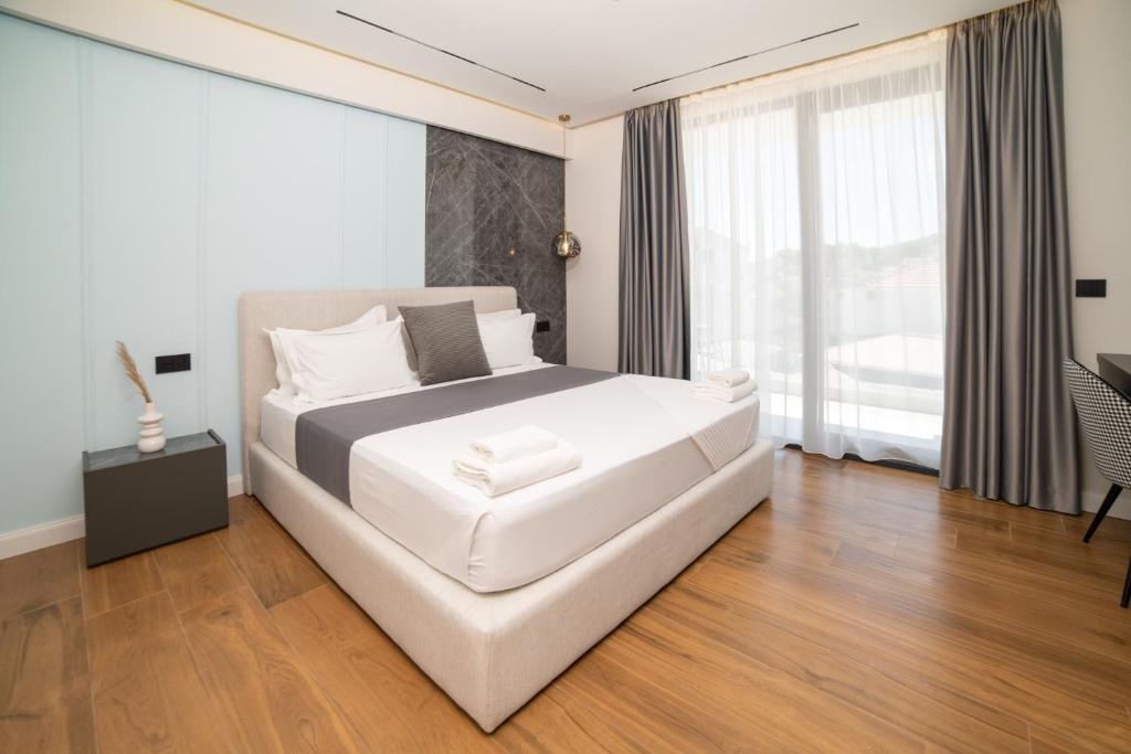 Postel nebo postele na pokoji v ubytování Hotel Teuta