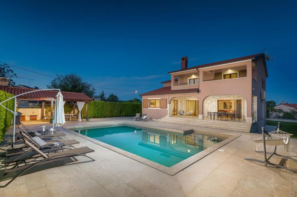 a swimming pool in front of a house at Villa Anastasia in Sveti Petar u Šumi