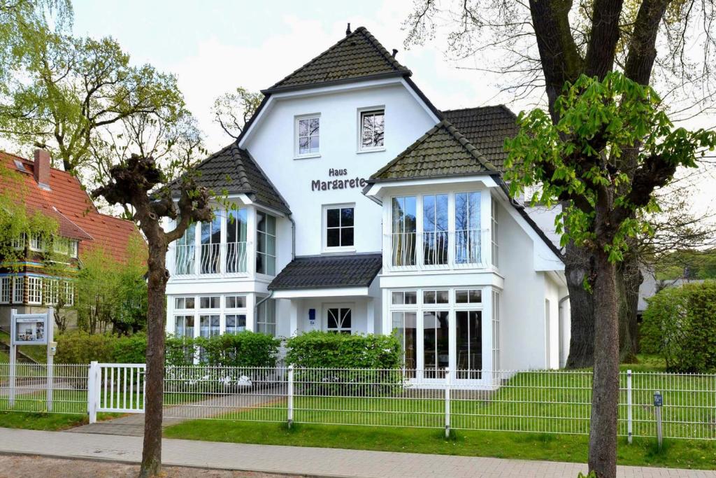 a white house with a black roof at Haus Margarete by Rujana in Binz
