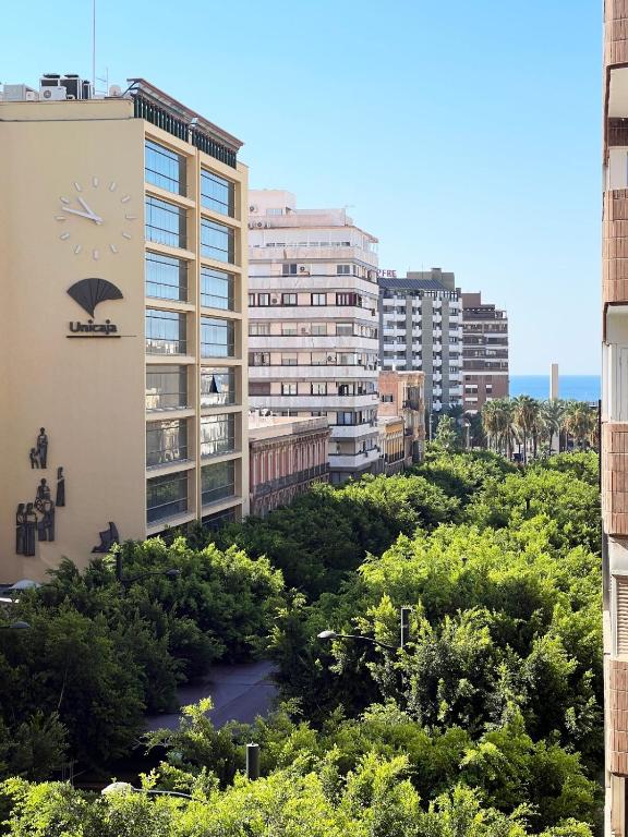 a view of a city with tall buildings at AT Paseo Ficus Centenario in Almería