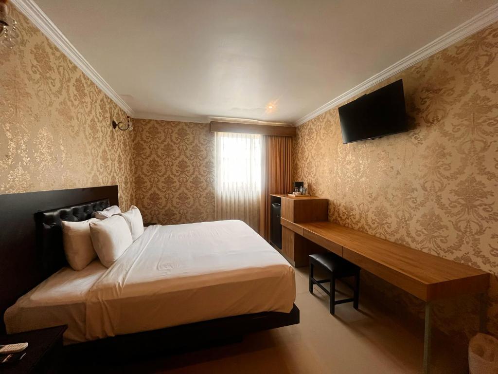 Postel nebo postele na pokoji v ubytování Hotel Palacio Maya