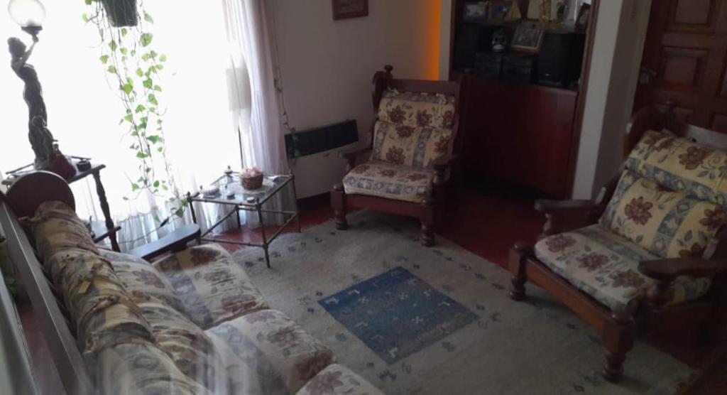 a living room with a couch and two chairs at Sandy in Cordoba