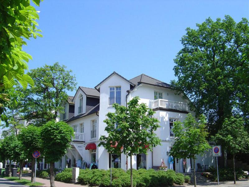 a large white building on the side of a street at Villa Saxonia by Rujana in Binz