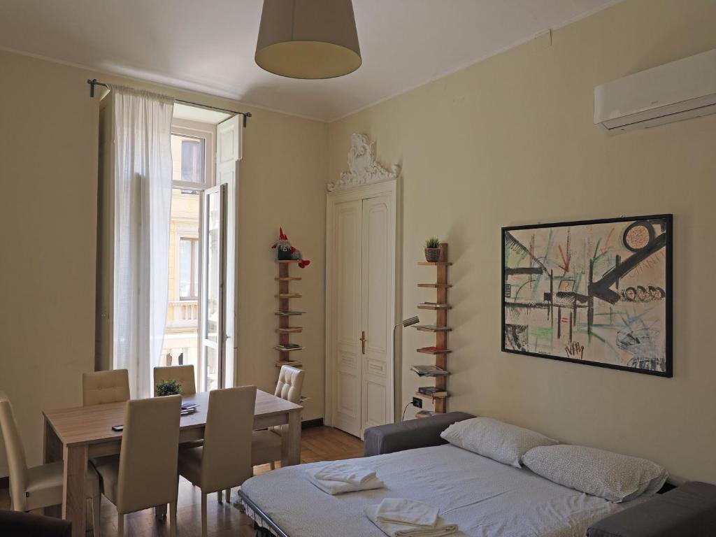 ein Wohnzimmer mit einem Sofa und einem Tisch sowie ein Esszimmer in der Unterkunft Inappartamento La Pepita Luxury in Turin