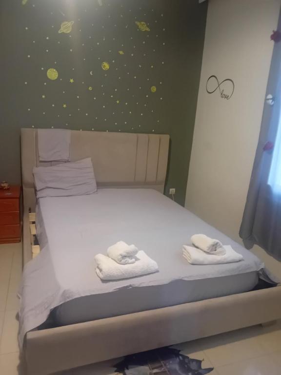 a bedroom with a bed with two towels on it at IRINIS HOUSES in Rhodes Town