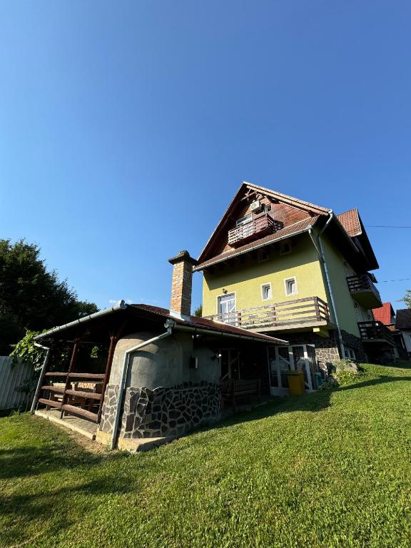 an old house sitting on top of a grass field at Casa Jeremiás in Sovata