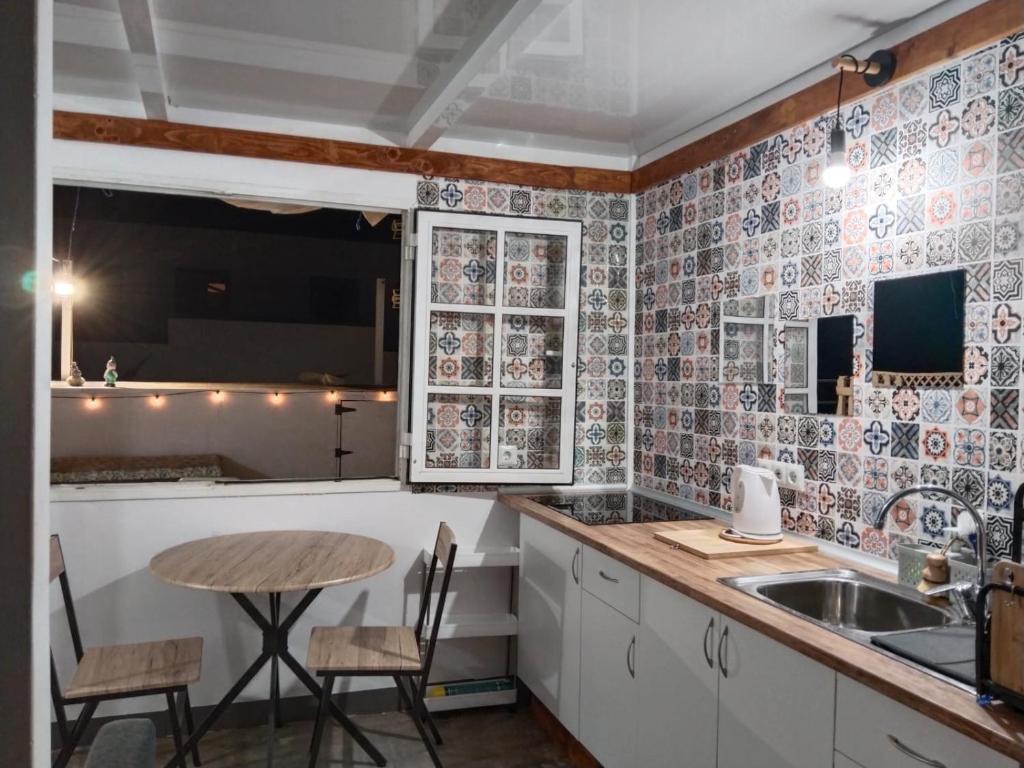 a kitchen with a table and a sink at La Nasita in Caleta de Sebo