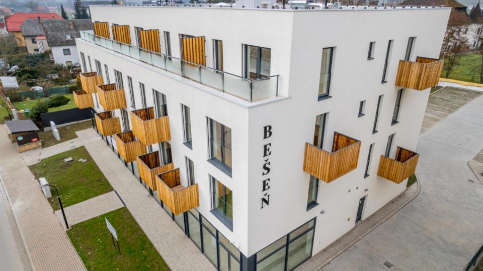 an aerial view of a building with wooden balconies at Apartmán NAD RIEKOU in Bešeňová