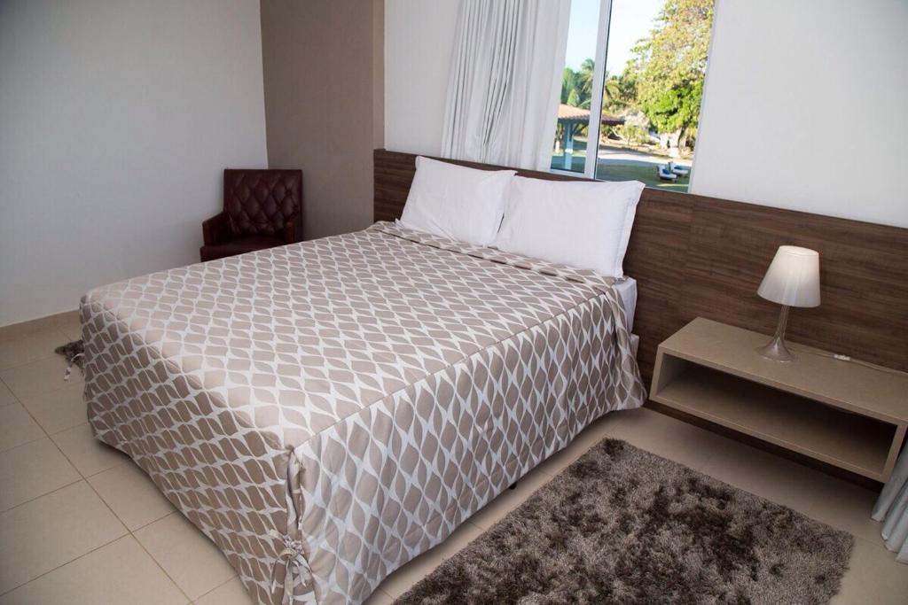 Ένα ή περισσότερα κρεβάτια σε δωμάτιο στο Pousada Villa das Palmeiras