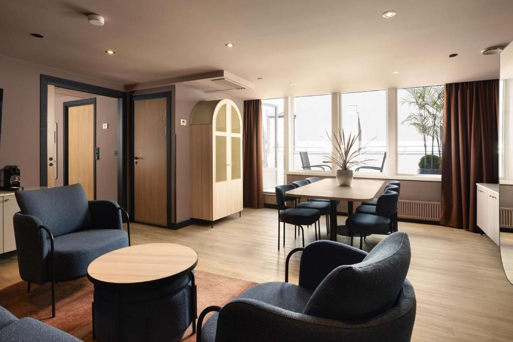 a living room with a table and chairs at Scandic Victoria in Oslo