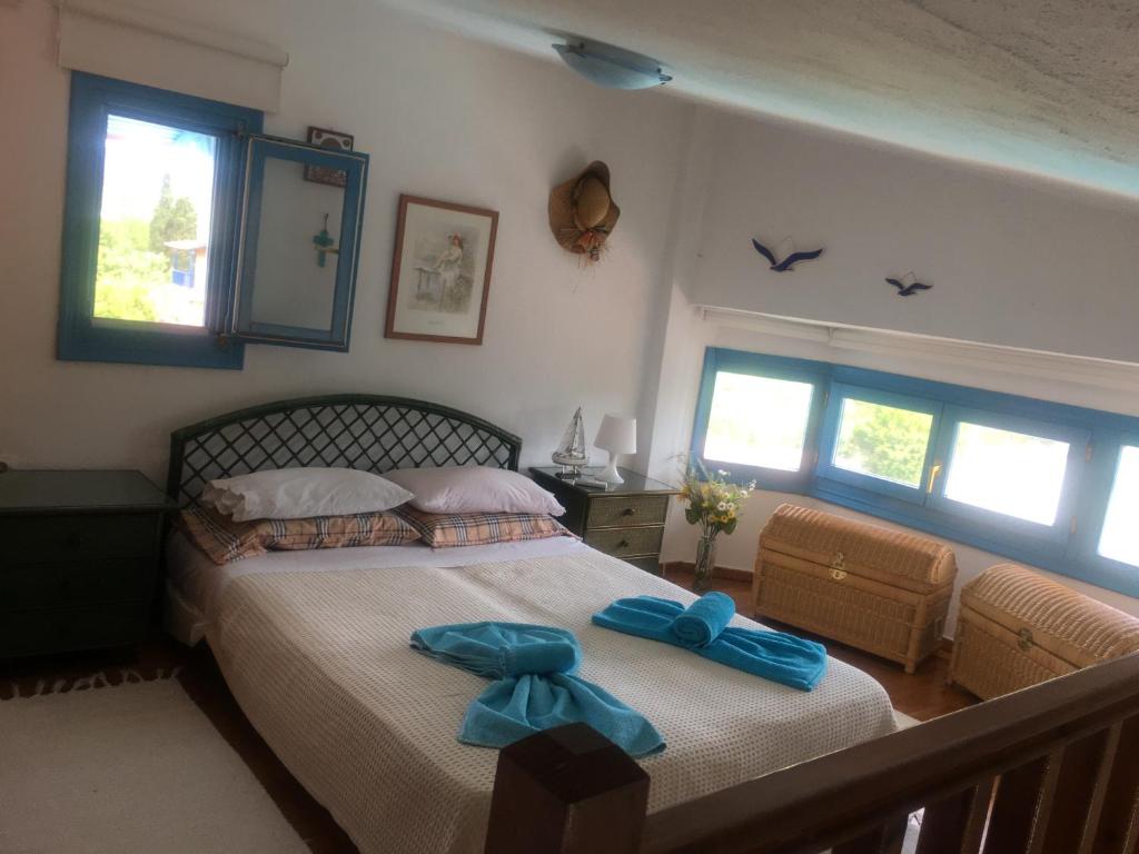 a bedroom with a bed with blue bows on it at Blue house in Kalandra