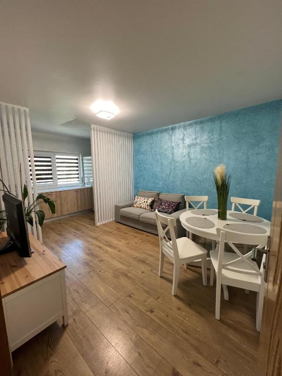 a living room with a table and a couch at Miva Apartments in Mangalia