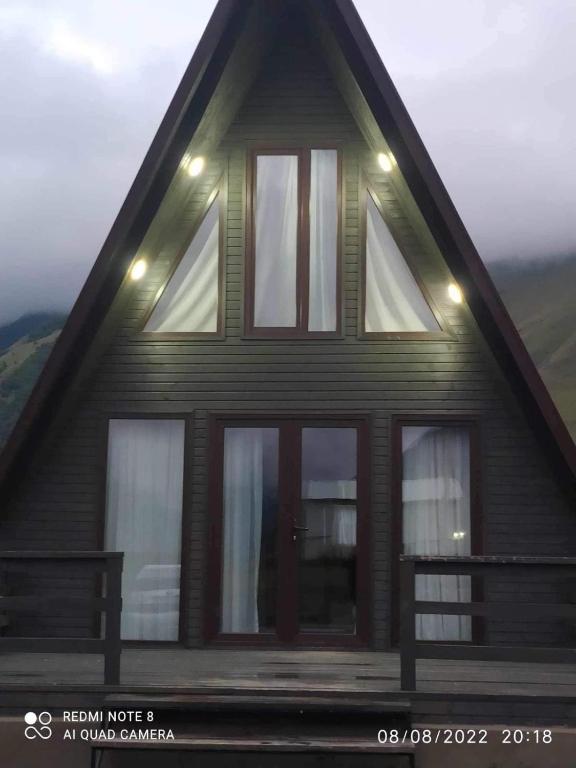 a house with windows on the side of it at Kazbegi Mountain View Cottage in Kazbegi
