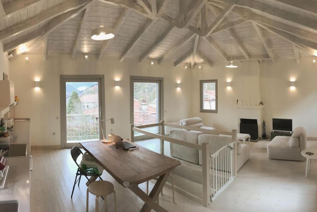 a living room with a couch and a table at Footpath House / Ολόκληρο σπίτι στο Μεγάλο Χωριό in Méga Khoríon