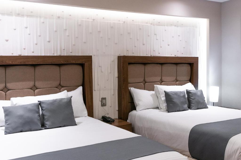Postel nebo postele na pokoji v ubytování Hotel Arthemisa