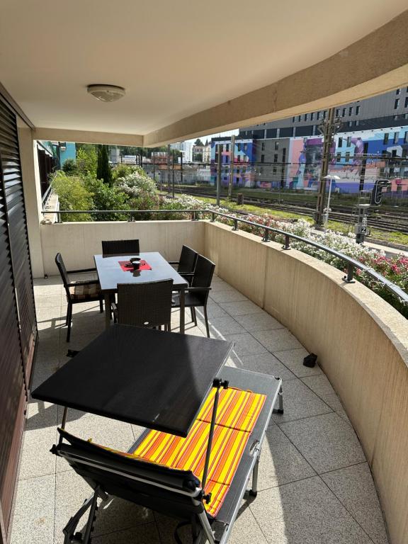 un patio avec une table et des chaises sur un balcon dans l'établissement Résidence le Carré Saint Roch, à Montpellier
