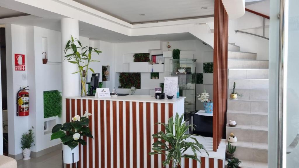 a lobby with a red and white striped counter at Hotel Atenas City in San Andrés