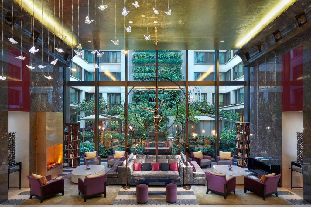a library with a chandelier in a building at Mandarin Oriental, Paris in Paris