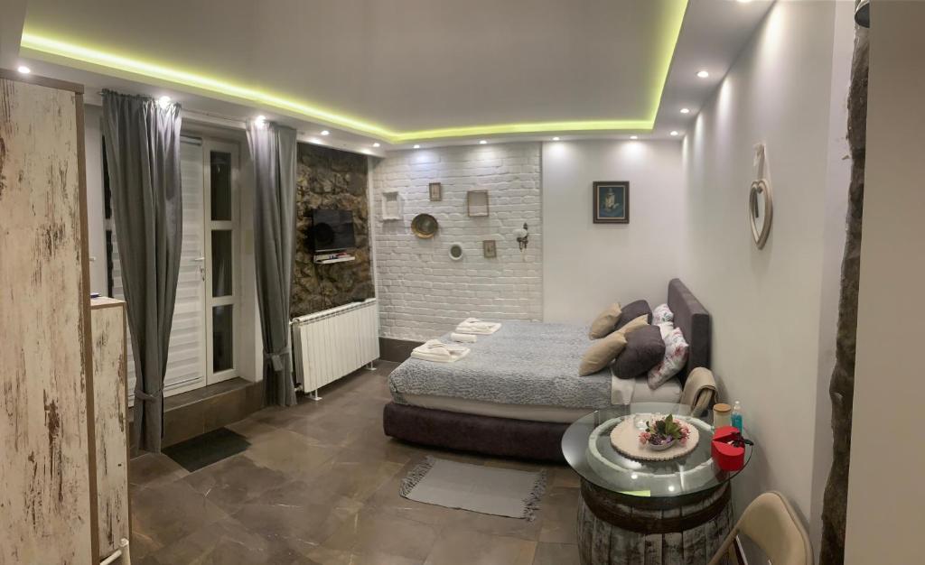 a bedroom with a bed and a table in a room at Apartman Nina BANOVO BRDO in Belgrade