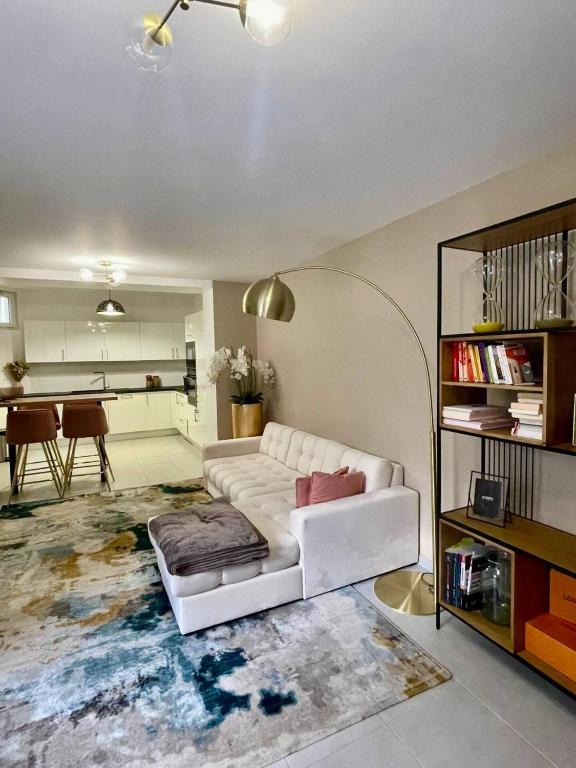 a living room with a white couch and a table at Nice area 5 minutes from Paris in Suresnes