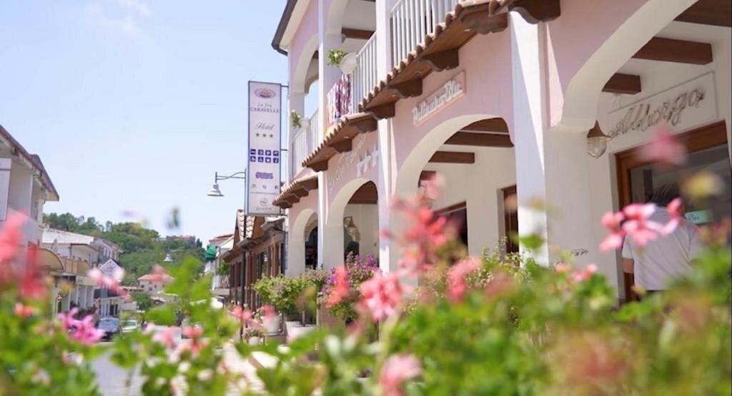 a row of buildings with flowers in front of them at Hotel Le Tre Caravelle in Palinuro