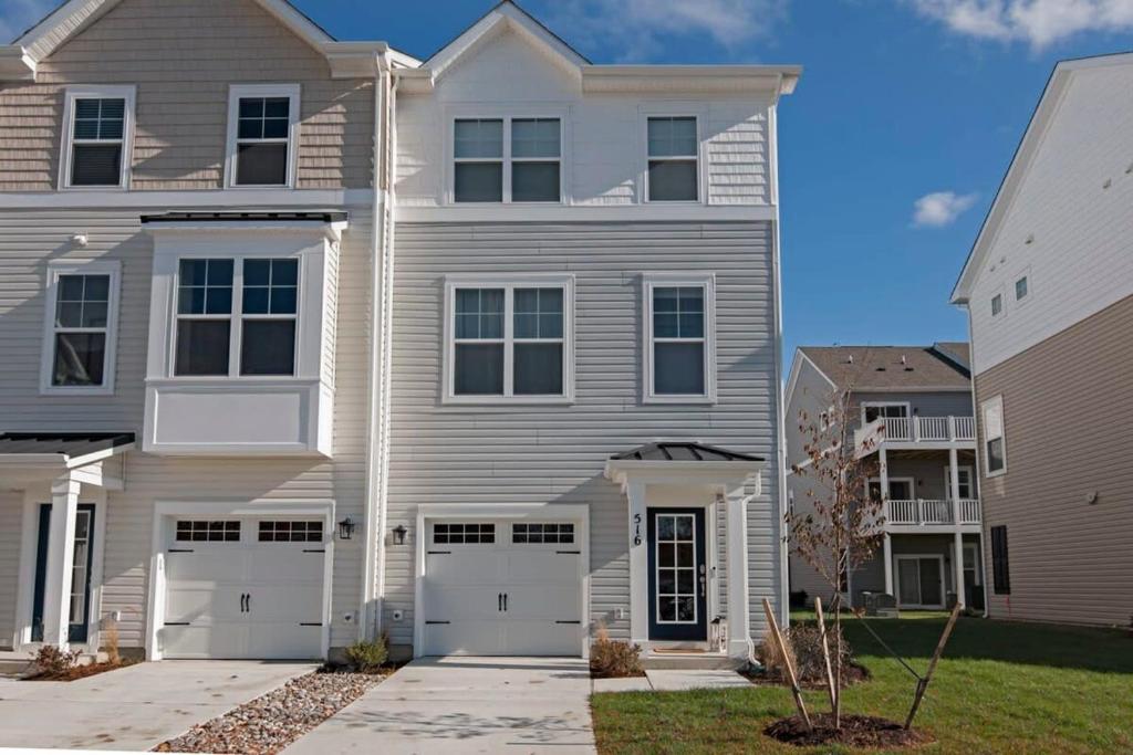 a large white house with two garages at New Intown Waterfront Townhome wPool & Location in Cambridge