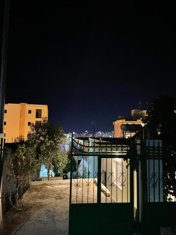 a view of a building at night with buildings at Joal Rooms in Sarandë
