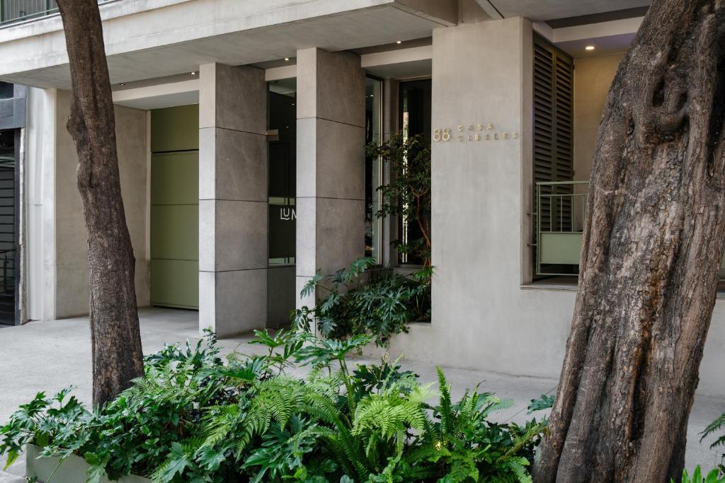 a building with plants in front of it at Casa Cibeles by Lumina in Mexico City