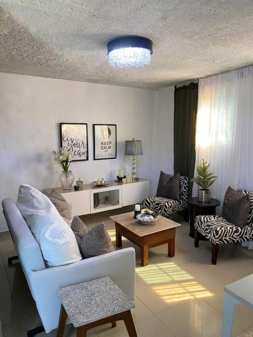 a living room with a couch and a table at bleesed House aeropuerto in Monte Adentro
