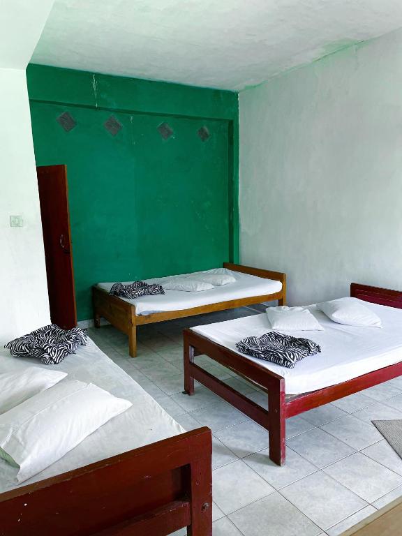 Postel nebo postele na pokoji v ubytování New Uduwara Guest