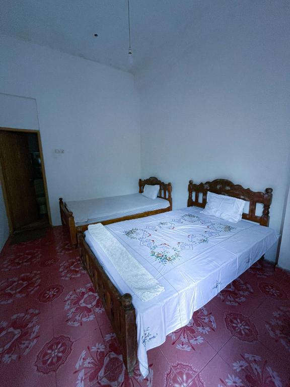 Postel nebo postele na pokoji v ubytování New Uduwara Guest
