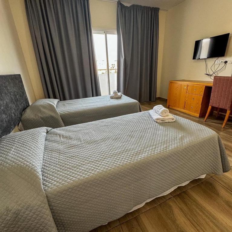 Postel nebo postele na pokoji v ubytování M. Moniatis Hotel