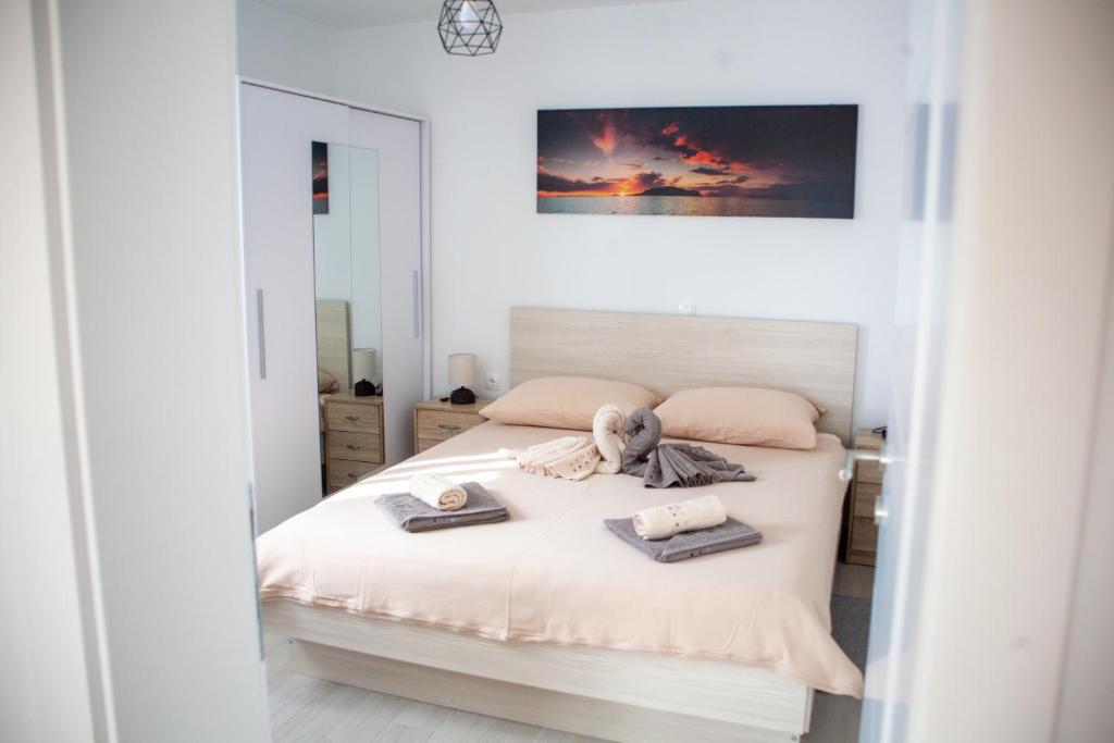 a bedroom with a bed with a teddy bear on it at Holiday House Rose in Karlobag