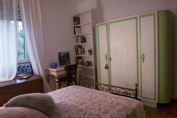 a bedroom with a bed and a green cabinet at Fior di Loto in Ravenna