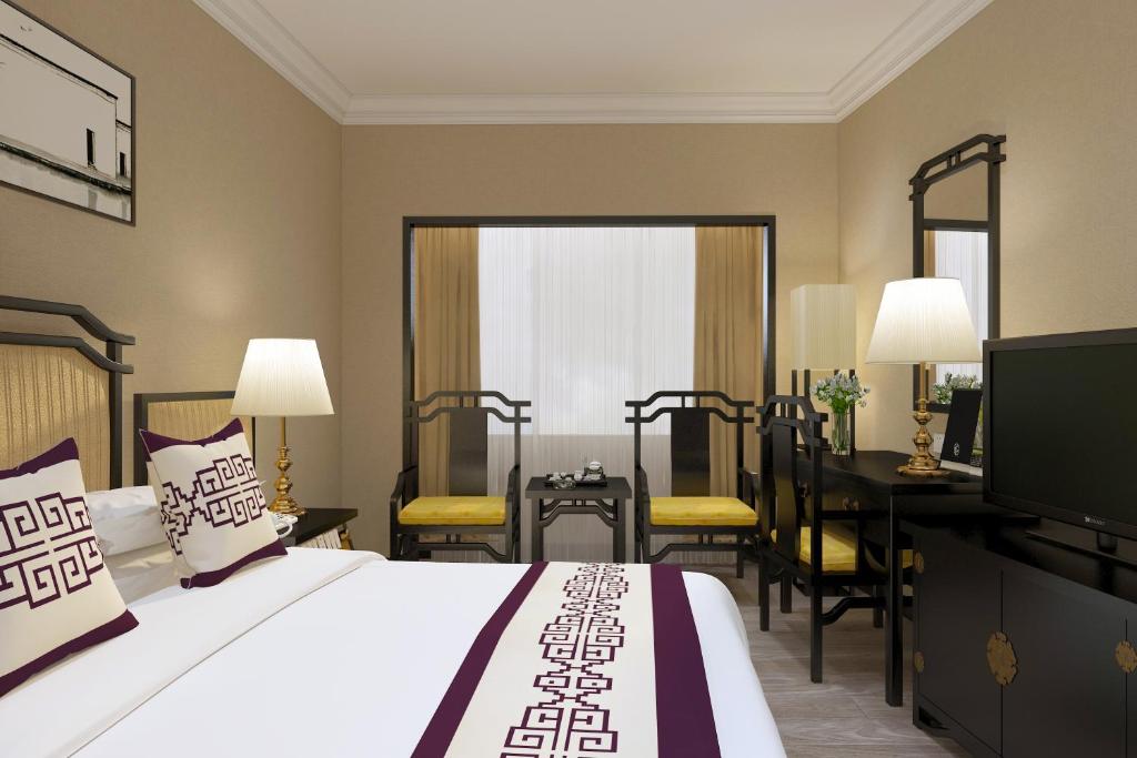 Postel nebo postele na pokoji v ubytování Yindo Jasper Hotel Zhuhai