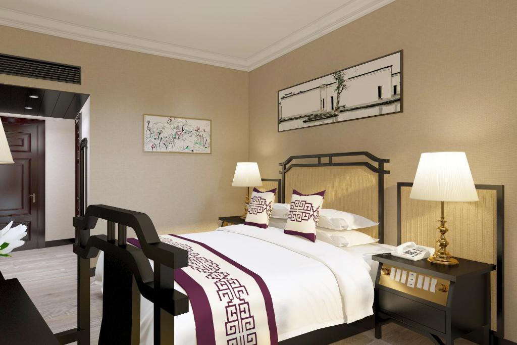 Postel nebo postele na pokoji v ubytování Yindo Jasper Hotel Zhuhai
