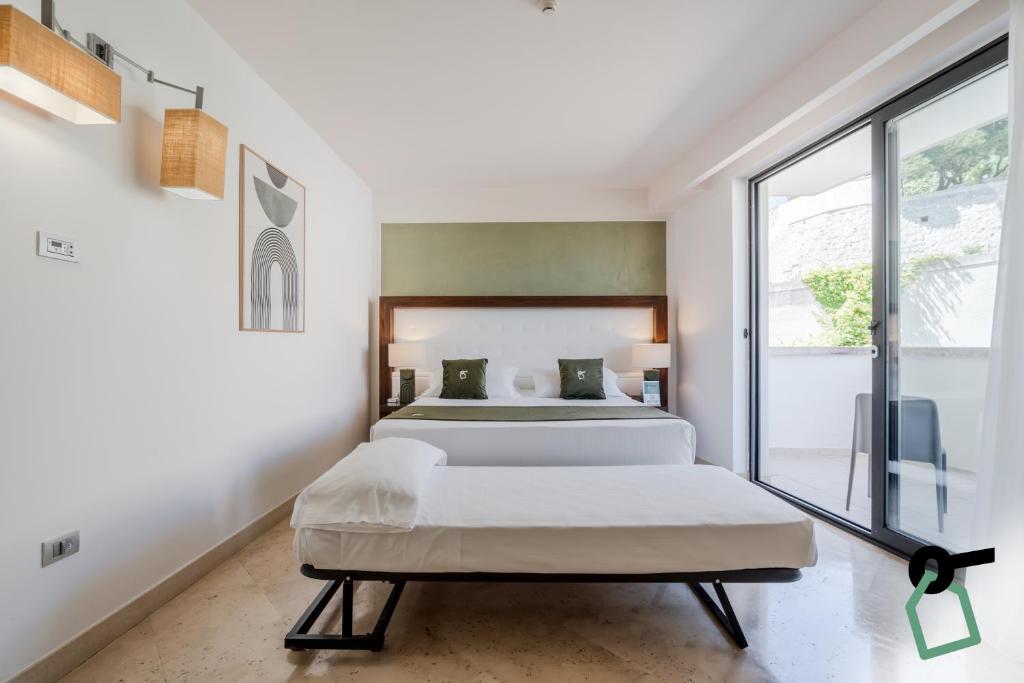 Postel nebo postele na pokoji v ubytování Hotiday Room Collection - Otranto