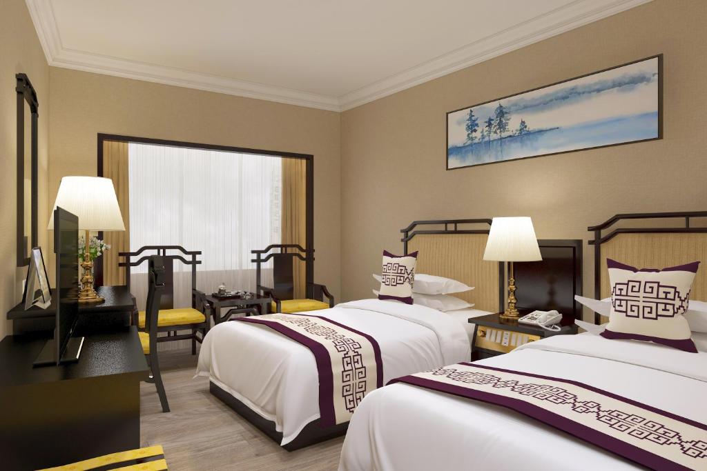 Postel nebo postele na pokoji v ubytování Yindo Jasper Hotel Zhuhai