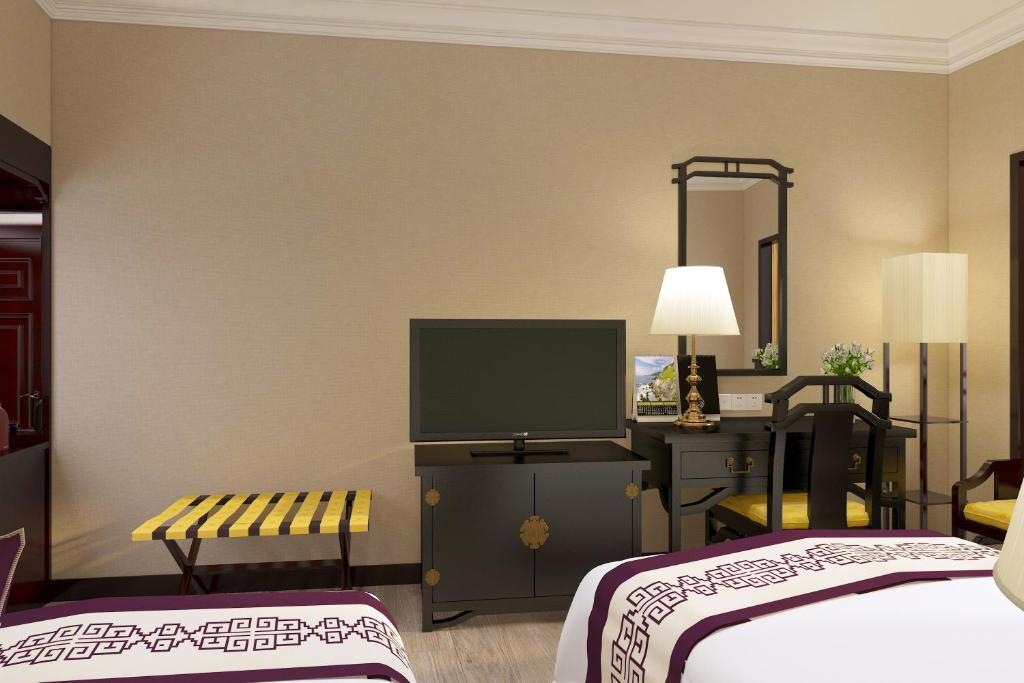 Postel nebo postele na pokoji v ubytování Yindo Jasper Hotel Zhuhai