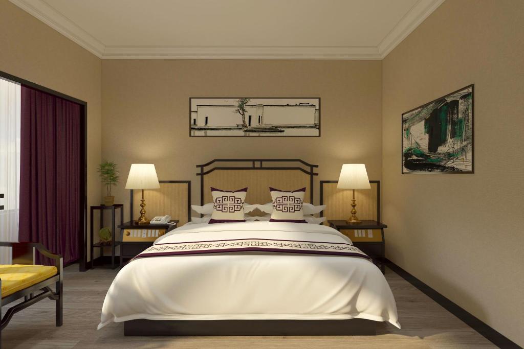 Postel nebo postele na pokoji v ubytování Yindo Jasper Hotel Zhuhai