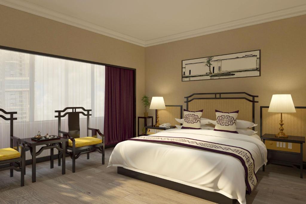 Postel nebo postele na pokoji v ubytování Yindo Jasper Hotel Zhuhai