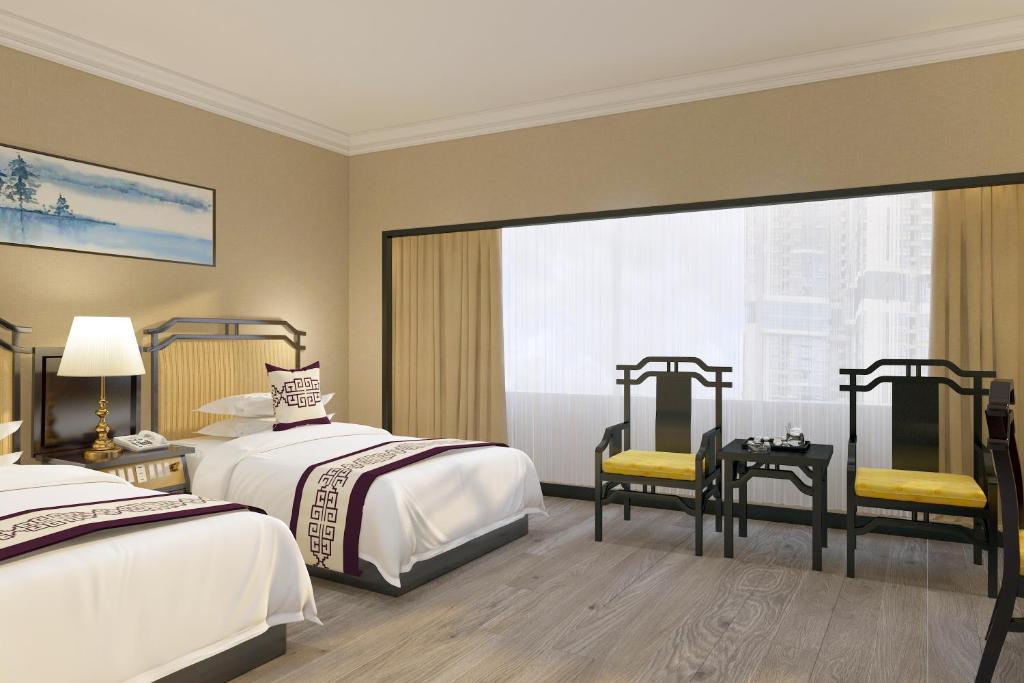 Postel nebo postele na pokoji v ubytování Yindo Jasper Hotel Zhuhai