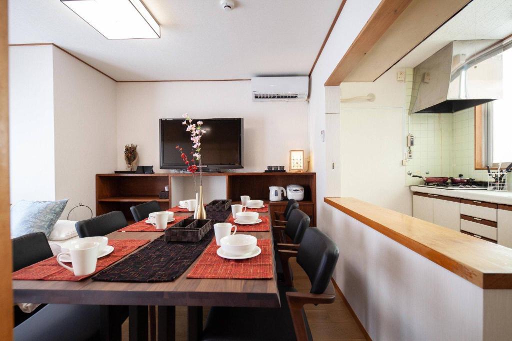 a dining room with a long table with chairs at Daini Kuwamura Building 4th in Tokyo