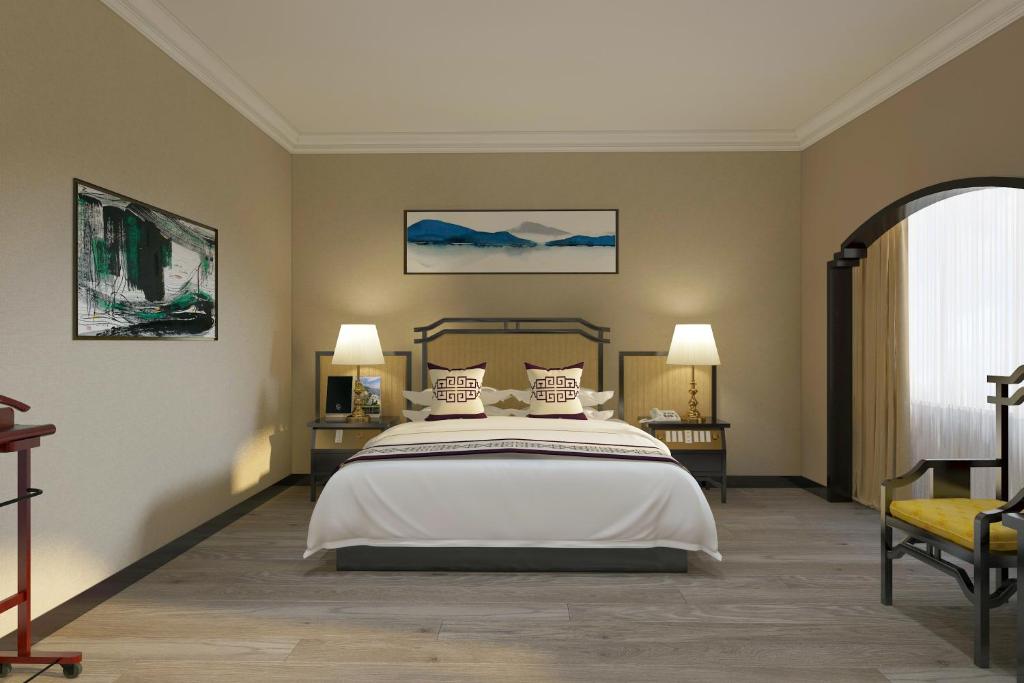 Postel nebo postele na pokoji v ubytování Yindo Jasper Hotel Zhuhai