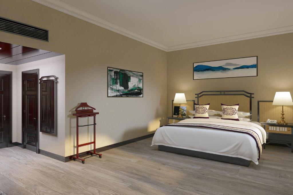 Postel nebo postele na pokoji v ubytování Yindo Jasper Hotel Zhuhai